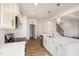 Bright kitchen features white cabinets, quartz countertops, stainless steel appliances, and stylish pendant lighting at 231 Trescott St, Smithfield, NC 27577