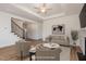Staged living area featuring staircase with iron spindles, hardwood floors, and furniture at 231 Trescott St, Smithfield, NC 27577