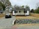 Charming cottage-style home with a cozy front porch, fresh landscaping, and a newly graveled driveway at 2316 Radiance Dr, Burlington, NC 27215