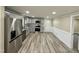 Open kitchen featuring gray cabinets, stainless steel appliances, granite counters, and hardwood floors at 2316 Radiance Dr, Burlington, NC 27215