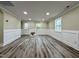 Spacious living room with fresh paint, white wainscoting, hardwood floors, and ample natural light at 2316 Radiance Dr, Burlington, NC 27215