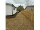 This property showcases a newly fenced in side yard with fresh landscaping at 2316 Radiance Dr, Burlington, NC 27215