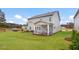 Spacious backyard view showcasing a large yard and a screened patio at 245 E Fountainhead Ln # 161, Garner, NC 27529