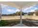 Covered patio with view of a large, unfinished backyard and neighboring houses at 246 Trescott St, Smithfield, NC 27577