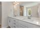Bathroom featuring double sinks with modern fixtures, and a large mirror at 246 Trescott St, Smithfield, NC 27577