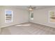 Bright bedroom with neutral carpet and three large windows for plenty of natural light at 246 Trescott St, Smithfield, NC 27577