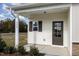 Charming front porch featuring a detailed entry door, window, and manicured landscaping at 246 Trescott St, Smithfield, NC 27577