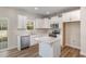 Modern kitchen with white cabinets, stainless steel appliances, and a functional island at 246 Trescott St, Smithfield, NC 27577
