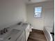 Neutral bathroom with a double vanity, a combination shower and tub, and wood floors at 253 Trescott St, Smithfield, NC 27577