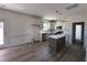 Bright kitchen with stainless appliances, white cabinets, island, and tile backsplash at 253 Trescott St, Smithfield, NC 27577