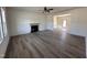 Spacious living room featuring a fireplace, ceiling fan, wood floors, and neutral paint at 253 Trescott St, Smithfield, NC 27577