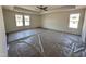 Large bedroom with tray ceiling, ceiling fan and bright natural light from many windows at 253 Trescott St, Smithfield, NC 27577