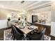 Elegant dining room with a modern chandelier, a table set for six, and hardwood floors at 276 E Fountainhead Ln # 166, Garner, NC 27529