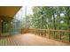 Back deck with railings, a screened-in porch, and surrounded by lush trees at 2765 Rue Sans Famille, Raleigh, NC 27607