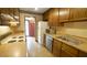 Efficient kitchen featuring wood cabinets, laminate countertops, and essential appliances at 2765 Rue Sans Famille, Raleigh, NC 27607