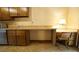 Efficient kitchen with wooden cabinets, countertop workspace, and a built-in desk at 2765 Rue Sans Famille, Raleigh, NC 27607