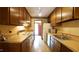 Traditional kitchen with wood cabinets, laminate countertops, and essential appliances at 2765 Rue Sans Famille, Raleigh, NC 27607