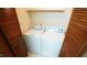 Cozy laundry area with appliances neatly placed between wooden closet doors at 2765 Rue Sans Famille, Raleigh, NC 27607
