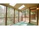 Enclosed patio space with skylights featuring views of the green backyard and a wooden deck at 2765 Rue Sans Famille, Raleigh, NC 27607