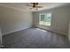 Cozy bedroom with neutral carpeting, a ceiling fan, and a bright window at 28 Bailey-Boykin Rd, Selma, NC 27576