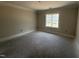 Unfinished bedroom with neutral paint and a bright window at 28 Bailey-Boykin Rd, Selma, NC 27576