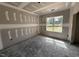 Bedroom under construction with window looking out to the front yard at 28 Bailey-Boykin Rd, Selma, NC 27576