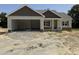 Newly constructed one-story home with a two-car garage and stone and shingle accents on the facade at 28 Bailey-Boykin Rd, Selma, NC 27576
