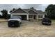 A single-Gathering home featuring a spacious garage, complemented by a black pickup truck at 28 Bailey-Boykin Rd, Selma, NC 27576