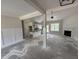 Spacious living room with fireplace and wainscoting that flows into a kitchen with an island at 28 Bailey-Boykin Rd, Selma, NC 27576