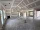 Large living room under construction featuring fireplace, large windows, and high ceilings at 28 Bailey-Boykin Rd, Selma, NC 27576