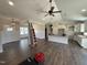 Open-concept living space with hardwood floors, ceiling fan, and modern lighting fixtures at 28 Bailey-Boykin Rd, Selma, NC 27576