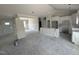 Unfinished living room with an open floor plan to the kitchen featuring white cabinets at 28 Bailey-Boykin Rd, Selma, NC 27576