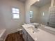 Clean, modern bathroom with white cabinetry, quartz countertop, and updated fixtures at 282 Trescott St, Smithfield, NC 27577