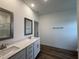 Bathroom featuring double sinks, quartz countertops, and a shower and bath at 282 Trescott St, Smithfield, NC 27577
