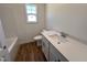 Bathroom with a tub, toilet, single sink vanity, modern faucet, and wood-look flooring at 282 Trescott St, Smithfield, NC 27577