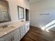 Bathroom with double sink vanity, quartz countertops, wood look floors and modern fixtures at 282 Trescott St, Smithfield, NC 27577