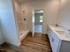 Bathroom featuring a walk-in shower, modern double vanity with countertop space, and an open view to the bedroom at 282 Trescott St, Smithfield, NC 27577