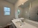 Bright bathroom featuring a large mirror, a white countertop vanity, and a window for natural light at 282 Trescott St, Smithfield, NC 27577