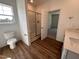 Bathroom featuring a glass-enclosed shower, modern fixtures, and a wood look floor, providing a luxurious and functional space at 282 Trescott St, Smithfield, NC 27577