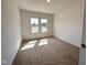 Well-lit bedroom boasting two windows, plush carpeting, and fresh, neutral paint at 282 Trescott St, Smithfield, NC 27577