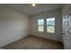 Well-lit carpeted bedroom with two windows offering ample natural light and neutral walls at 282 Trescott St, Smithfield, NC 27577