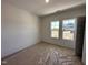 Carpeted bedroom with double windows providing natural light and a view of the neighborhood at 282 Trescott St, Smithfield, NC 27577