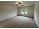 Spacious bedroom with plush carpeting and abundant natural light from large windows at 282 Trescott St, Smithfield, NC 27577