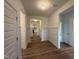 Inviting entryway featuring wood-look floors and decorative wainscoting leading into the home at 282 Trescott St, Smithfield, NC 27577