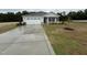 Charming single-story home with a concrete driveway and manicured lawn offers great curb appeal at 282 Trescott St, Smithfield, NC 27577