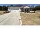Charming single Gathering home with a two-car garage, attractive landscaping, and a concrete driveway at 282 Trescott St, Smithfield, NC 27577