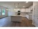 Bright kitchen with stainless steel appliances, a granite island, and ample cabinet space at 282 Trescott St, Smithfield, NC 27577