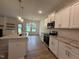 Bright kitchen featuring granite countertops, stainless appliances, and a breakfast bar island at 282 Trescott St, Smithfield, NC 27577