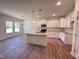 Beautiful kitchen with granite countertops, stainless steel appliances, a center island, and stylish pendant lighting at 282 Trescott St, Smithfield, NC 27577