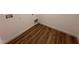 Laundry room with sleek wood-look flooring, utility connections, and white walls at 282 Trescott St, Smithfield, NC 27577
